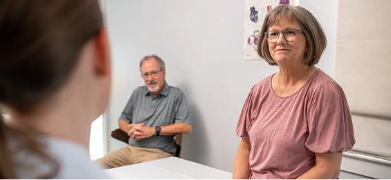 Patient at a doctor's office talking to a doctor.
