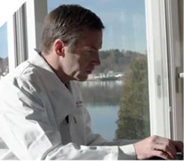 Dr. Ryan sitting at a desk.